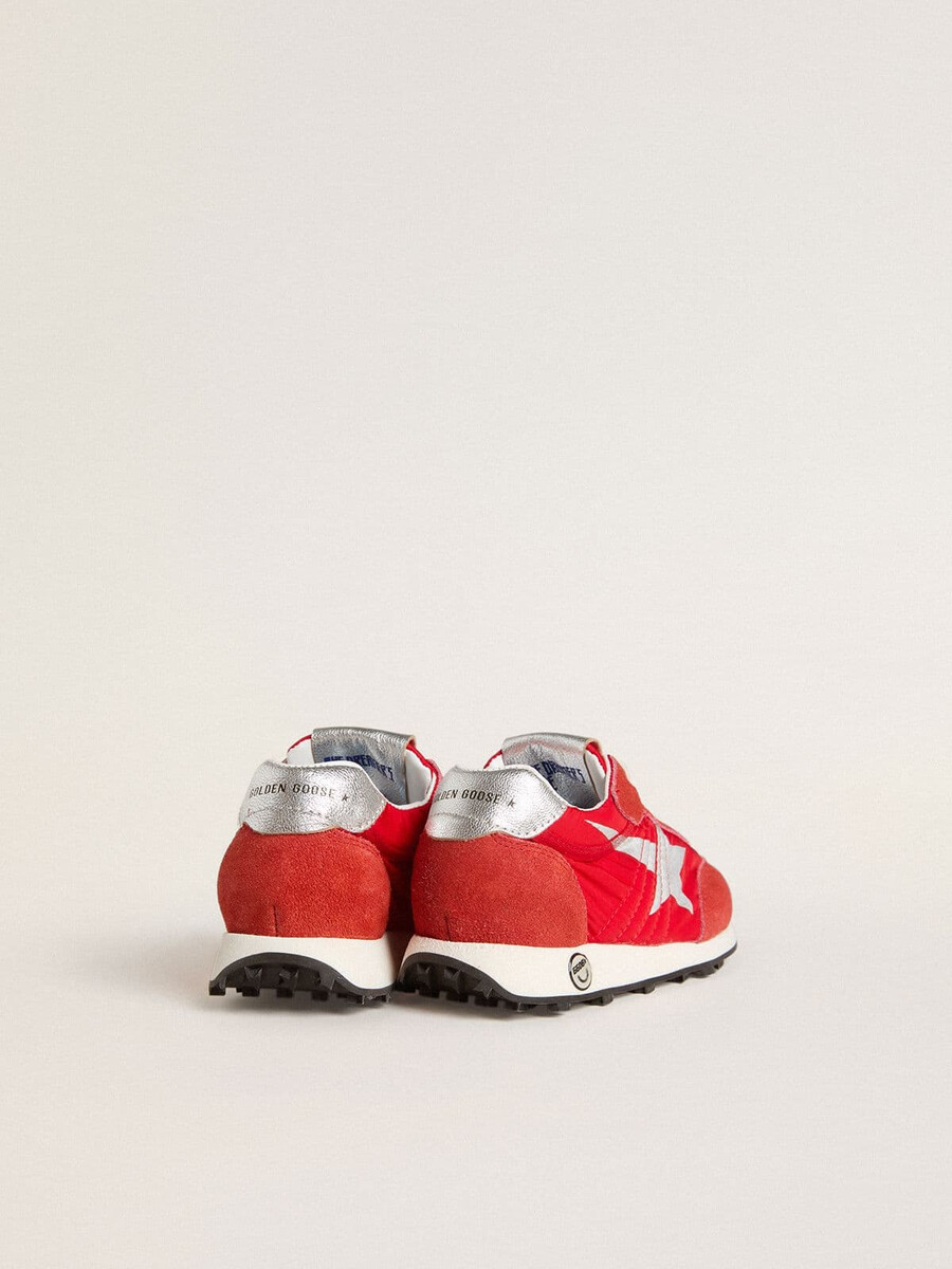 young marathon in rood nylon met bedrukte ster en leren hielstuk.